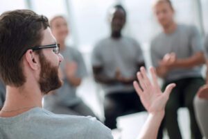 Man speaking during group therapy discussing ketamine addiction